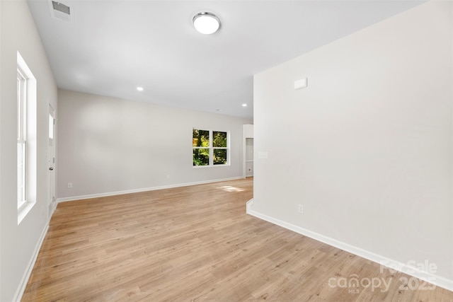 unfurnished room with light wood-style flooring, baseboards, and recessed lighting