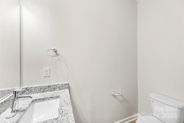 bathroom featuring toilet and vanity