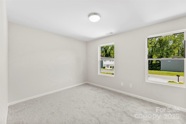 unfurnished room with baseboards and carpet flooring
