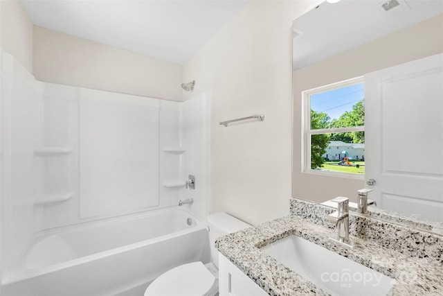 full bath with toilet, vanity, and  shower combination