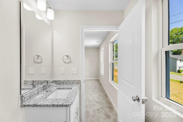 bathroom with vanity and baseboards