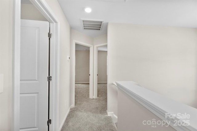 corridor featuring carpet and baseboards