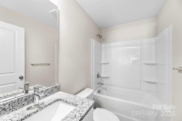 bathroom with toilet, vanity, and washtub / shower combination