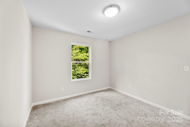 carpeted empty room with baseboards