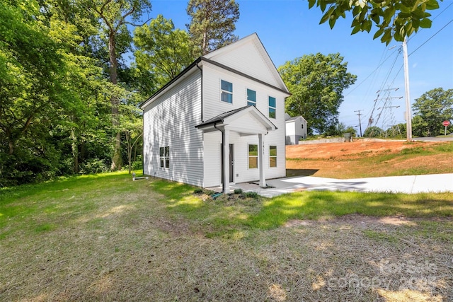 view of side of property with a patio and a yard