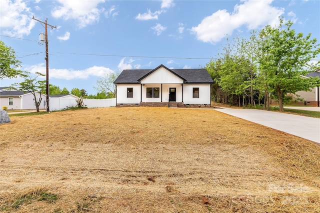 605 Stirewalt Rd, China Grove, NC 28023 - view of front of home featuring concrete driveway, roof with shingles, covered porch, and fence
