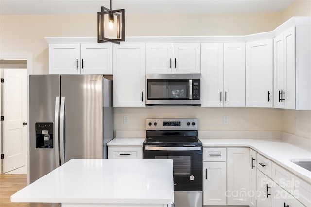 605 Stirewalt Rd, China Grove, NC 28023 - kitchen with appliances with stainless steel finishes, white cabinets, light countertops, pendant lighting, and a center island