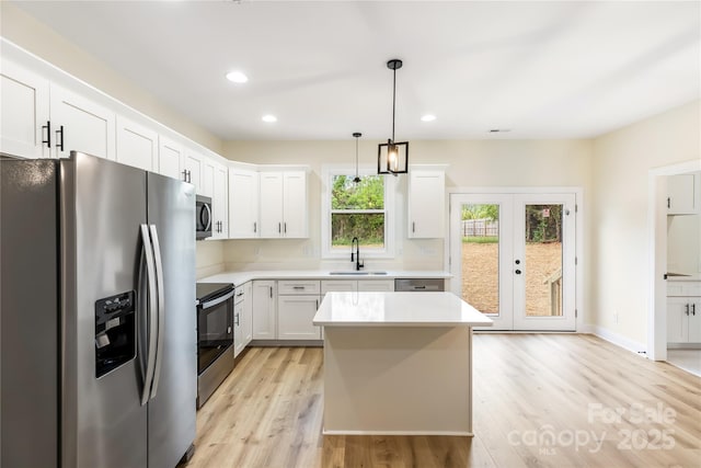 605 Stirewalt Rd, China Grove, NC 28023 - kitchen with appliances with stainless steel finishes, a sink, light countertops, light wood finished floors, and recessed lighting