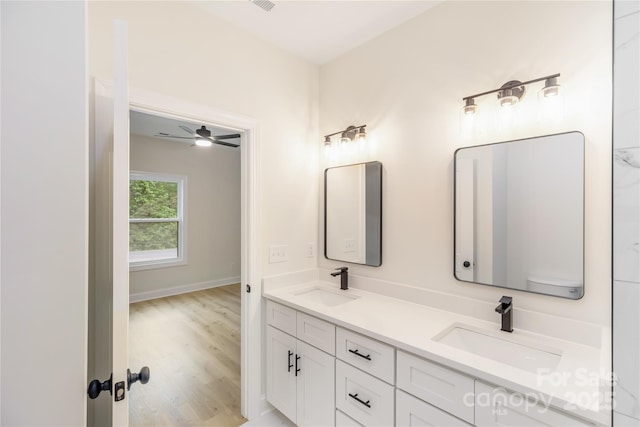 605 Stirewalt Rd, China Grove, NC 28023 - full bathroom with double vanity, wood finished floors, and a ceiling fan