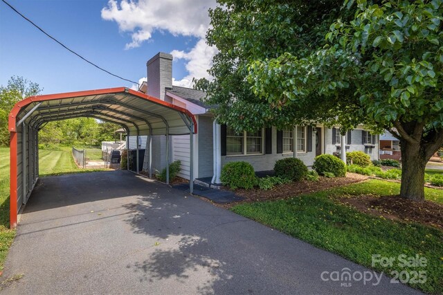 107 Pete Brittain Rd, Morganton, NC 28655 - view of parking with asphalt driveway and a carport