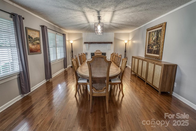 107 Pete Brittain Rd, Morganton, NC 28655 - dining space with dark wood-style floors, a textured ceiling, crown molding, and baseboards