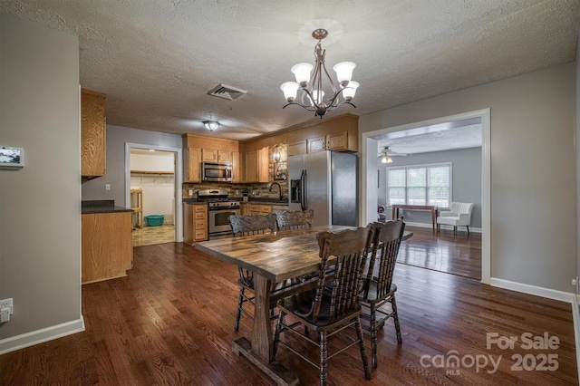 107 Pete Brittain Rd, Morganton, NC 28655 - dining room with dark wood-type flooring, a chandelier, baseboards, and a textured ceiling
