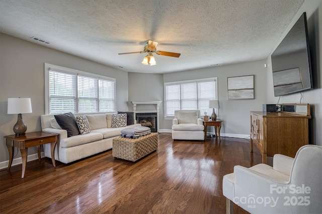 107 Pete Brittain Rd, Morganton, NC 28655 - living area featuring wood finished floors, ceiling fan, a fireplace, baseboards, and a textured ceiling