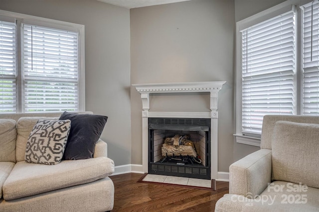 107 Pete Brittain Rd, Morganton, NC 28655 - living area featuring wood finished floors, healthy amount of natural light, a fireplace with flush hearth, and baseboards