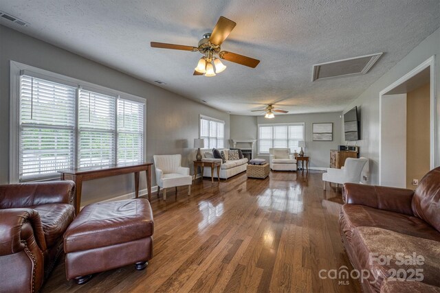 107 Pete Brittain Rd, Morganton, NC 28655 - living room featuring wood finished floors, a textured ceiling, ceiling fan, attic access, and baseboards