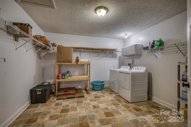 107 Pete Brittain Rd, Morganton, NC 28655 - clothes washing area featuring stone tile floors, independent washer and dryer, a textured ceiling, baseboards, and cabinet space