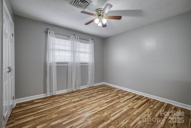 107 Pete Brittain Rd, Morganton, NC 28655 - unfurnished room with wood finished floors, baseboards, a ceiling fan, and a textured ceiling