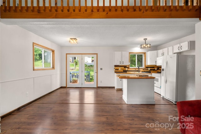 234 Snyder Farm Rd, Waynesville, NC 28786 - kitchen featuring white appliances, white cabinets, a sink, dark wood finished floors, and a kitchen island