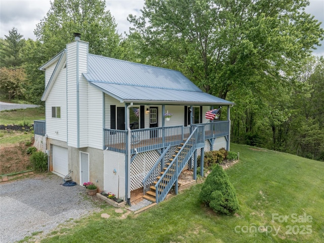 234 Snyder Farm Rd, Waynesville, NC 28786 - view of front of house featuring a porch, gravel driveway, a front yard, a chimney, and a garage