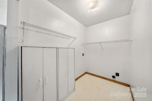 234 Snyder Farm Rd, Waynesville, NC 28786 - laundry room with a textured ceiling, hookup for a washing machine, baseboards, and hookup for an electric dryer