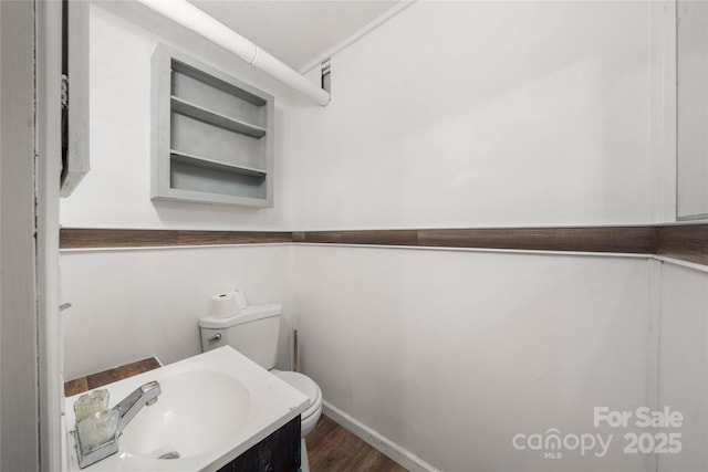 234 Snyder Farm Rd, Waynesville, NC 28786 - bathroom featuring toilet, wood finished floors, baseboards, and vanity