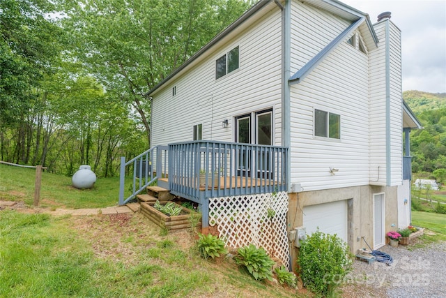 234 Snyder Farm Rd, Waynesville, NC 28786 - back of property featuring an attached garage, a chimney, a deck, and a yard