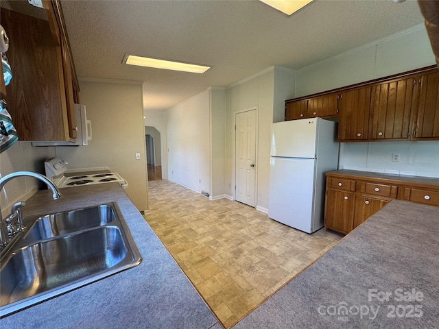 40 Mountainview Rd, Asheville, NC 28806 - kitchen featuring white appliances, a sink, arched walkways, a textured ceiling, and ornamental molding