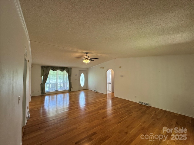 40 Mountainview Rd, Asheville, NC 28806 - unfurnished room with a textured ceiling, wood finished floors, arched walkways, ceiling fan, and baseboards