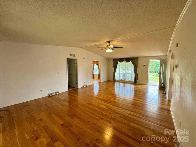 40 Mountainview Rd, Asheville, NC 28806 - unfurnished living room featuring a textured ceiling, wood finished floors, a ceiling fan, lofted ceiling, and baseboards