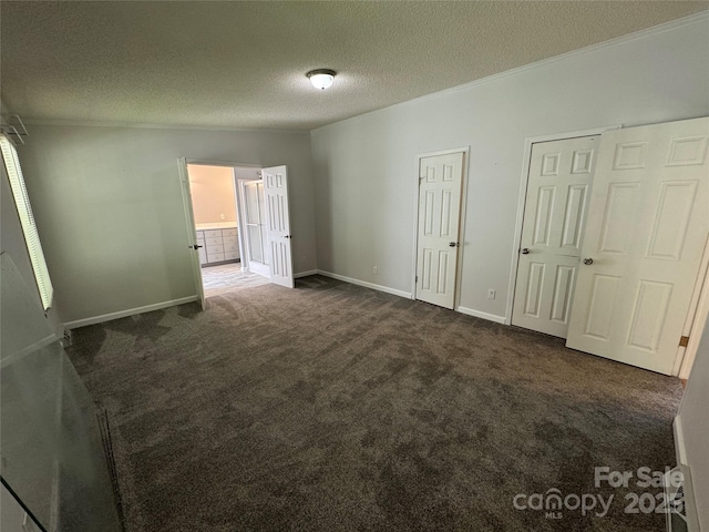 40 Mountainview Rd, Asheville, NC 28806 - unfurnished bedroom with multiple closets, dark carpet, a textured ceiling, ornamental molding, and baseboards