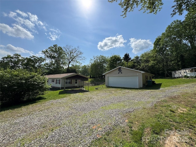 40 Mountainview Rd, Asheville, NC 28806 - view of front of home with an outdoor structure, a garage, a front lawn, and view of wooded area