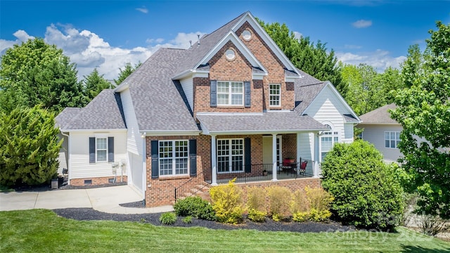 7245 Willow Brook Ct, Denver, NC 28037 - view of front of house with a porch, roof with shingles, brick siding, and a front yard