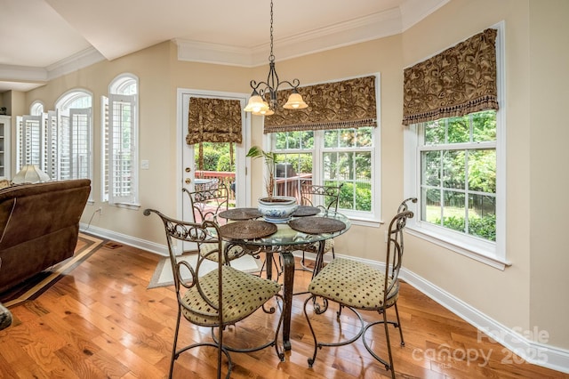 7245 Willow Brook Ct, Denver, NC 28037 - dining space with ornamental molding, healthy amount of natural light, baseboards, wood finished floors, and a chandelier