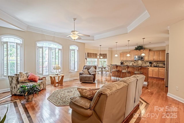 7245 Willow Brook Ct, Denver, NC 28037 - living area with light wood-style floors, a raised ceiling, ceiling fan, crown molding, and baseboards