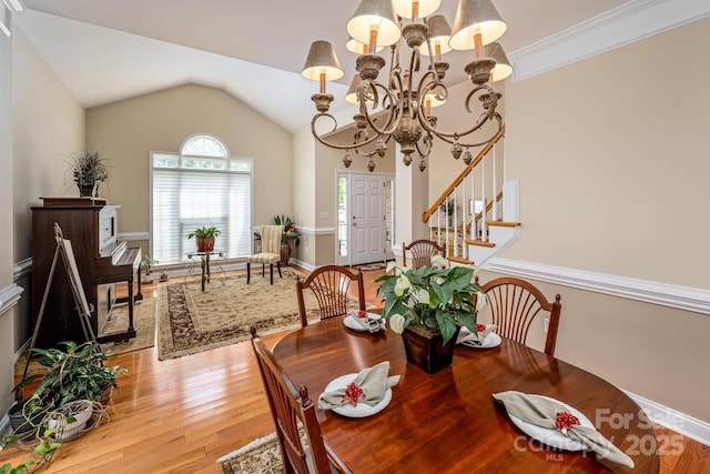 7245 Willow Brook Ct, Denver, NC 28037 - dining space with a chandelier, light wood finished floors, vaulted ceiling, and stairs