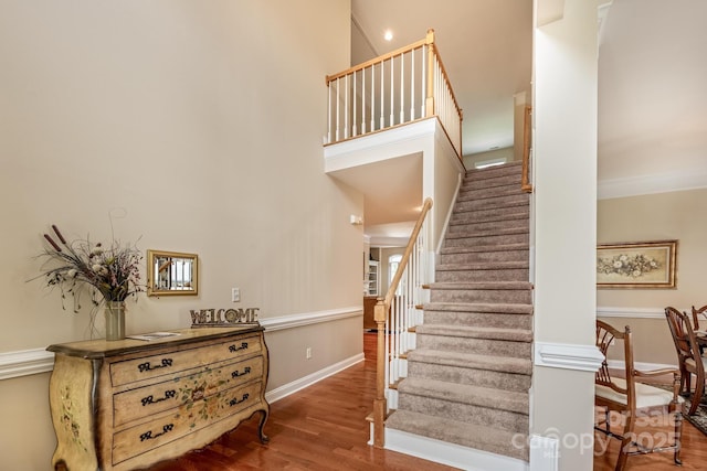 7245 Willow Brook Ct, Denver, NC 28037 - stairway featuring wood finished floors, baseboards, and a high ceiling
