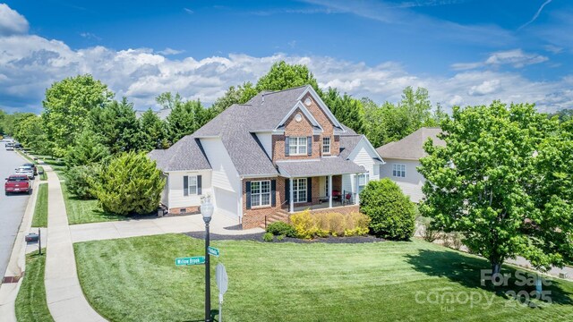 7245 Willow Brook Ct, Denver, NC 28037 - traditional-style home featuring a porch, a front yard, roof with shingles, driveway, and brick siding