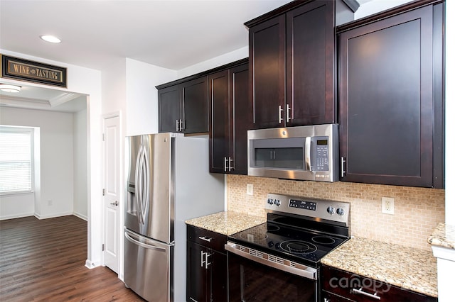 kitchen featuring stainless steel appliances, decorative backsplash, light stone counters, baseboards, and dark wood-style flooring