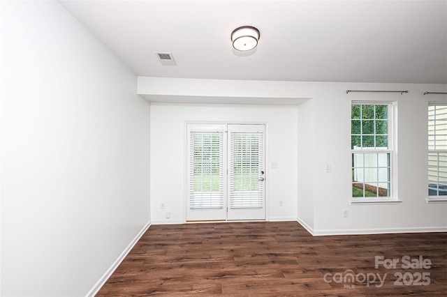 doorway to outside with dark wood-type flooring and baseboards