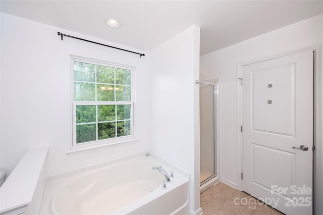 bathroom with a stall shower, a garden tub, tile patterned flooring, and recessed lighting