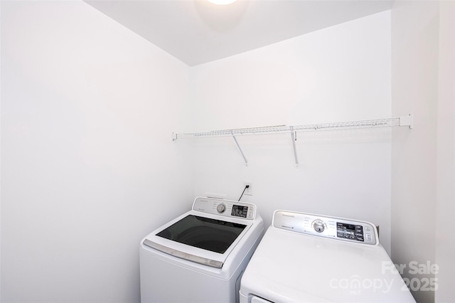clothes washing area with separate washer and dryer