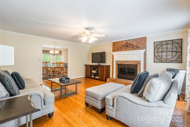 2730 Tiffany Dr, Rock Hill, SC 29732 - living room with ceiling fan, light wood-style floors, a chandelier, crown molding, and a fireplace