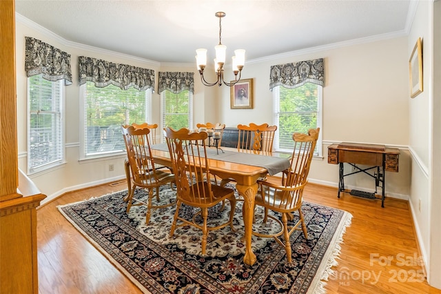 2730 Tiffany Dr, Rock Hill, SC 29732 - dining area with a chandelier, ornamental molding, light wood finished floors, and baseboards