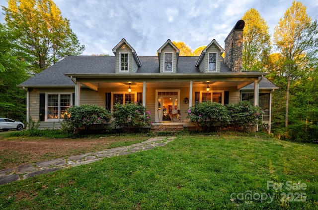 4398 Mud Puddle Ln, Lenoir, NC 28645 - cape cod-style house featuring a chimney, a front lawn, and covered porch
