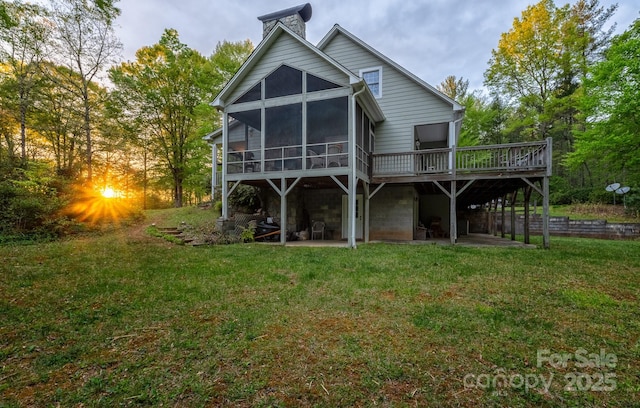 4398 Mud Puddle Ln, Lenoir, NC 28645 - rear view of house with a wooden deck, a lawn, a sunroom, and a patio area