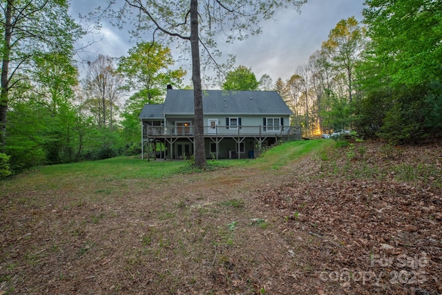 4398 Mud Puddle Ln, Lenoir, NC 28645 - rear view of house with a wooden deck, a chimney, and a lawn
