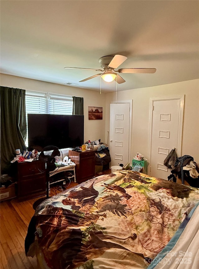 bedroom with wood finished floors and ceiling fan
