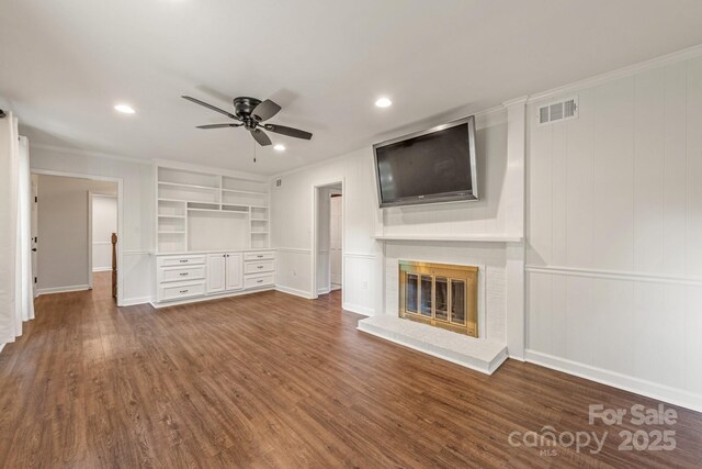 3101 Willowbrae Rd, Charlotte, NC 28226 - unfurnished living room featuring a ceiling fan, built in shelves, wood finished floors, a brick fireplace, and a decorative wall