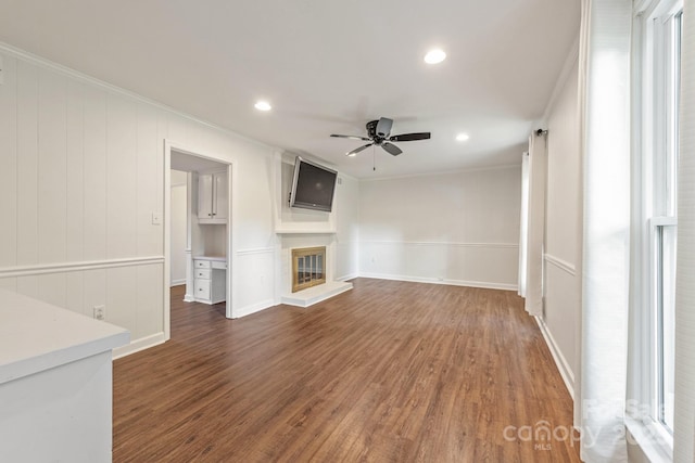 3101 Willowbrae Rd, Charlotte, NC 28226 - unfurnished living room featuring ceiling fan, crown molding, a glass covered fireplace, recessed lighting, and wood finished floors