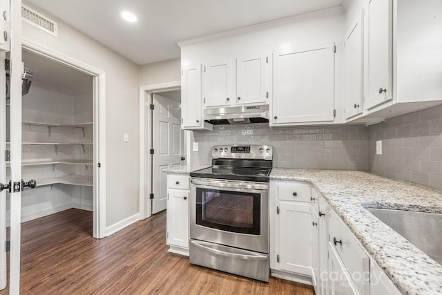 3101 Willowbrae Rd, Charlotte, NC 28226 - kitchen with stainless steel electric range oven, under cabinet range hood, white cabinets, tasteful backsplash, and recessed lighting